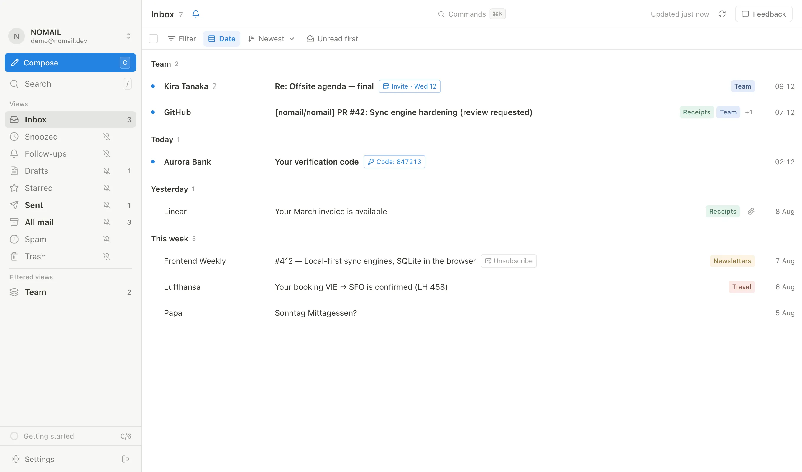 A split inbox: pinned Team section above the day-grouped stream, with labels and an extracted sign-in code on the rows
